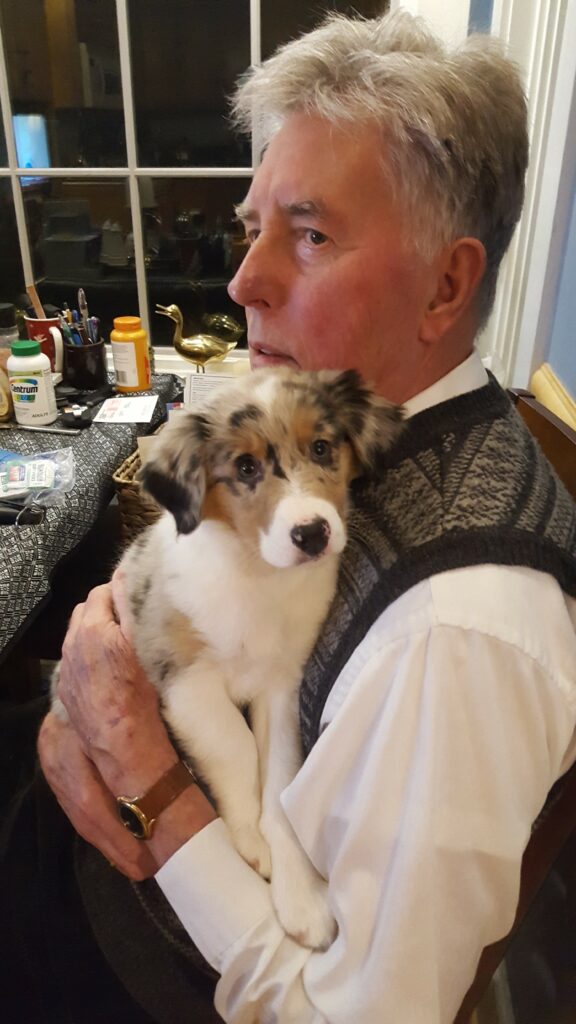 man holding a puppy